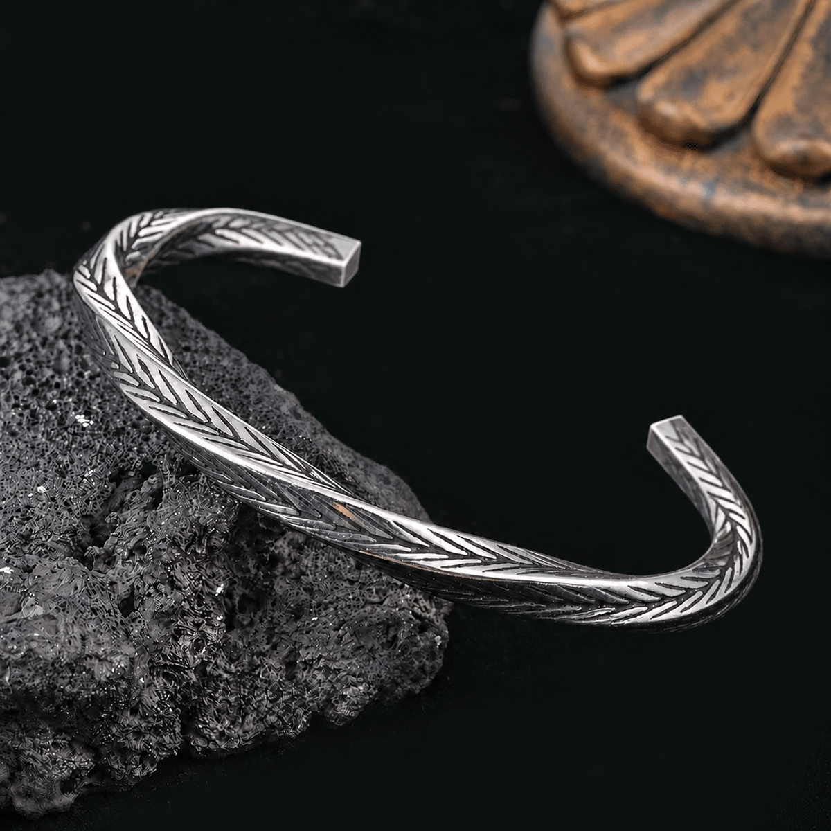 Close-up of Aether Cuff bracelet showing intricate engraved texture and polished silver-tone open ends