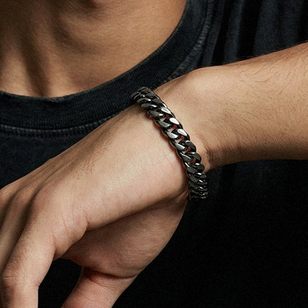 Men's Cuban Chain Bracelet worn with a black shirt showing its chunky Cuban link design
