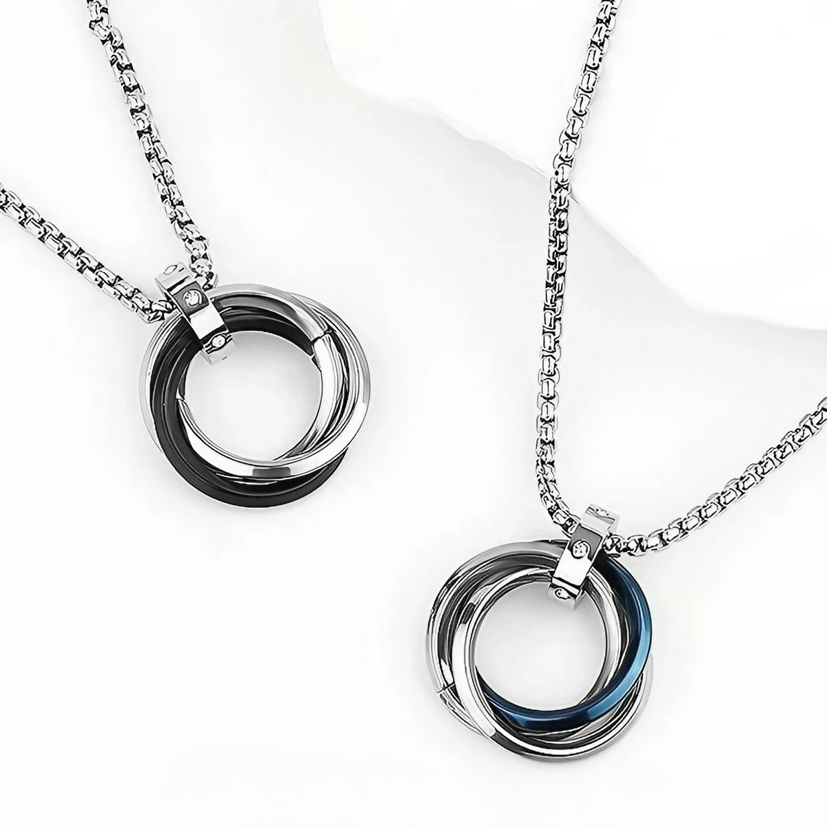 Interlocking Ring Necklace with silver-tone and blue-accented rings displayed on white background