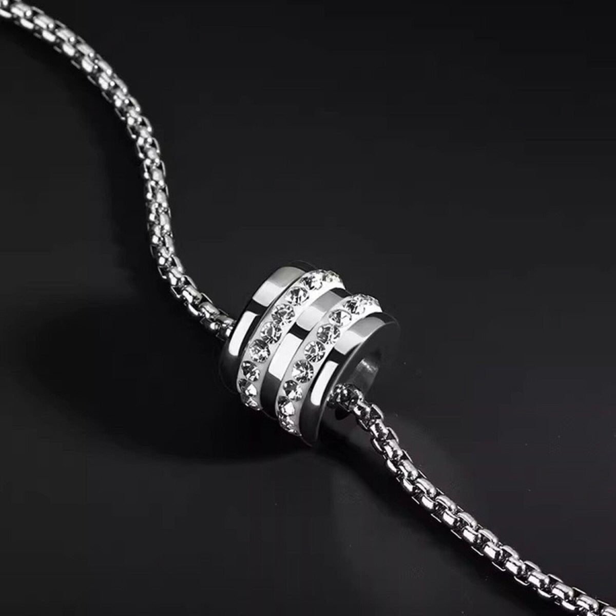 Macro detail of Pavé Barrel Necklace showing sparkling stones and textured silver-tone barrel pendant