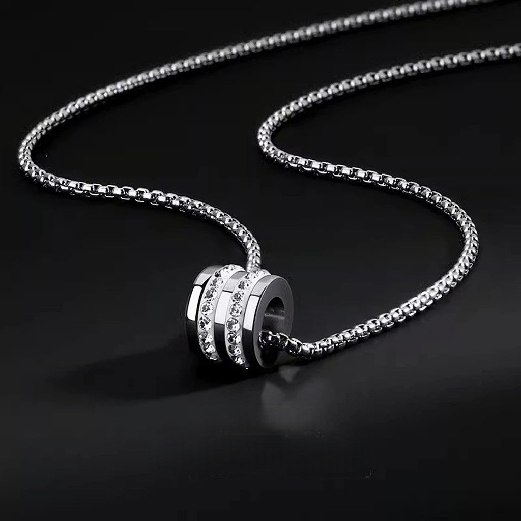 Close-up of Pavé Barrel Necklace featuring a pavé-set barrel pendant on a dark background