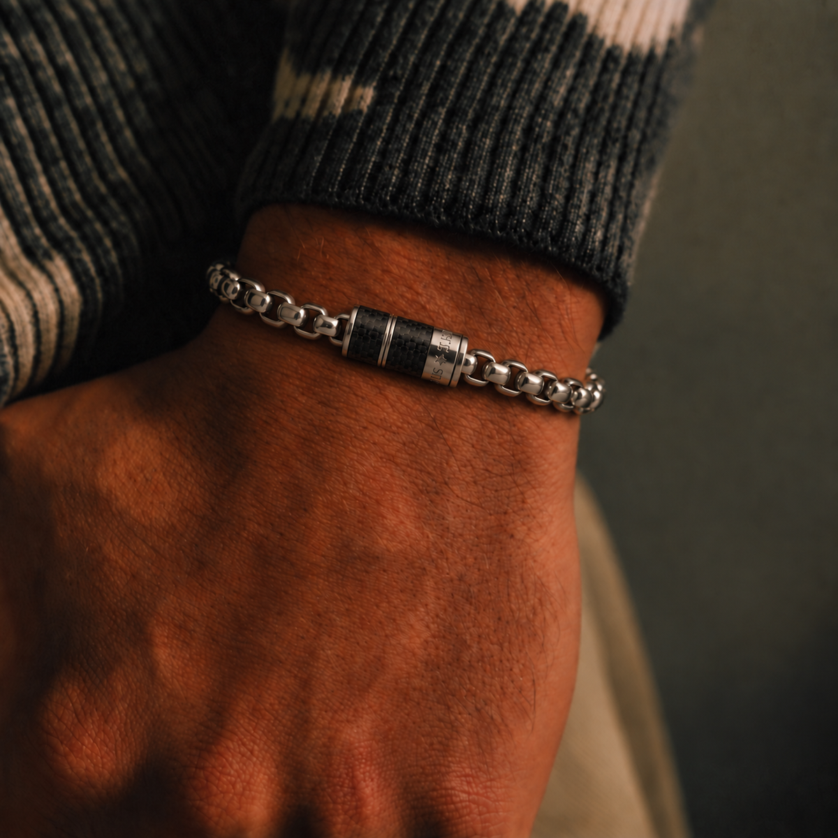 Carbon Core Bracelet worn with a black sweater highlighting its silver-tone links and dark accents