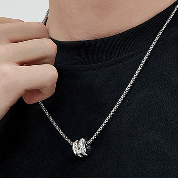 Men's Pavé Barrel Necklace styled with a black T-shirt and layered silver-tone chains