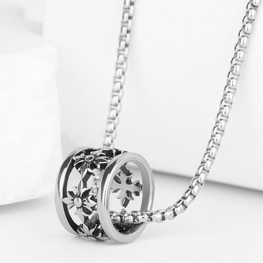 Close-up of Iris Bead Necklace featuring intricate engraved bead pendant and silver-tone chain