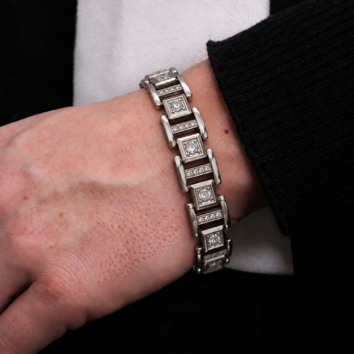 Close-up of Prism Link Bracelet on wrist showing its geometric metal links and polished finish