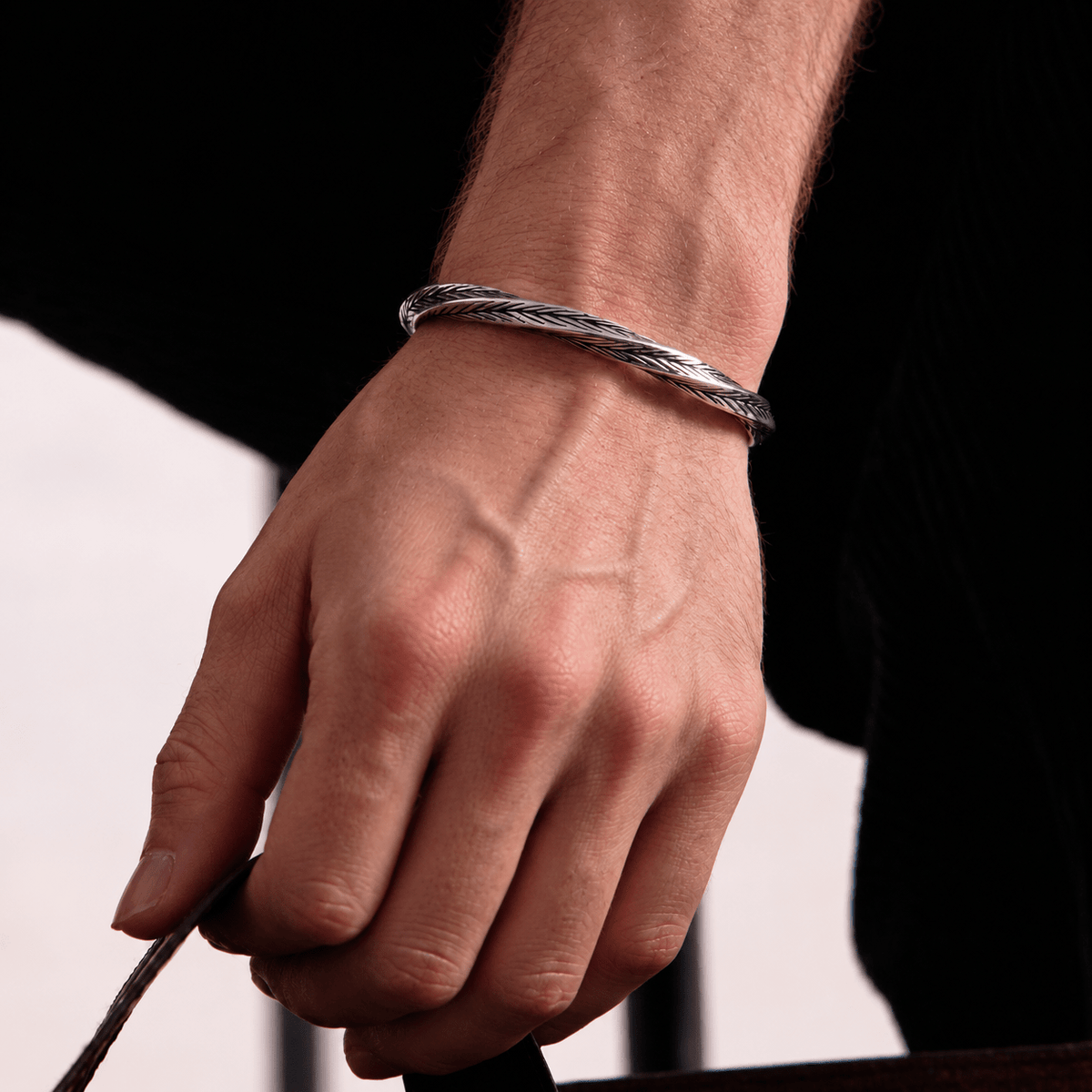 Men's Aether Cuff bracelet worn on wrist featuring a textured silver-tone finish and minimalist design