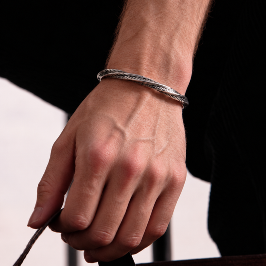 Men's Aether Cuff bracelet worn on wrist featuring a textured silver-tone finish and minimalist design