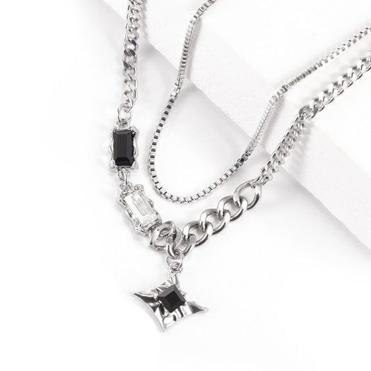Close-up of Starburst Layered Necklace featuring layered silver-tone chains and a starburst pendant