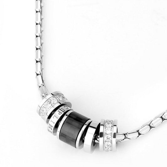 Close-up of Barrel Accent Necklace featuring polished silver-tone barrel details and chain links
