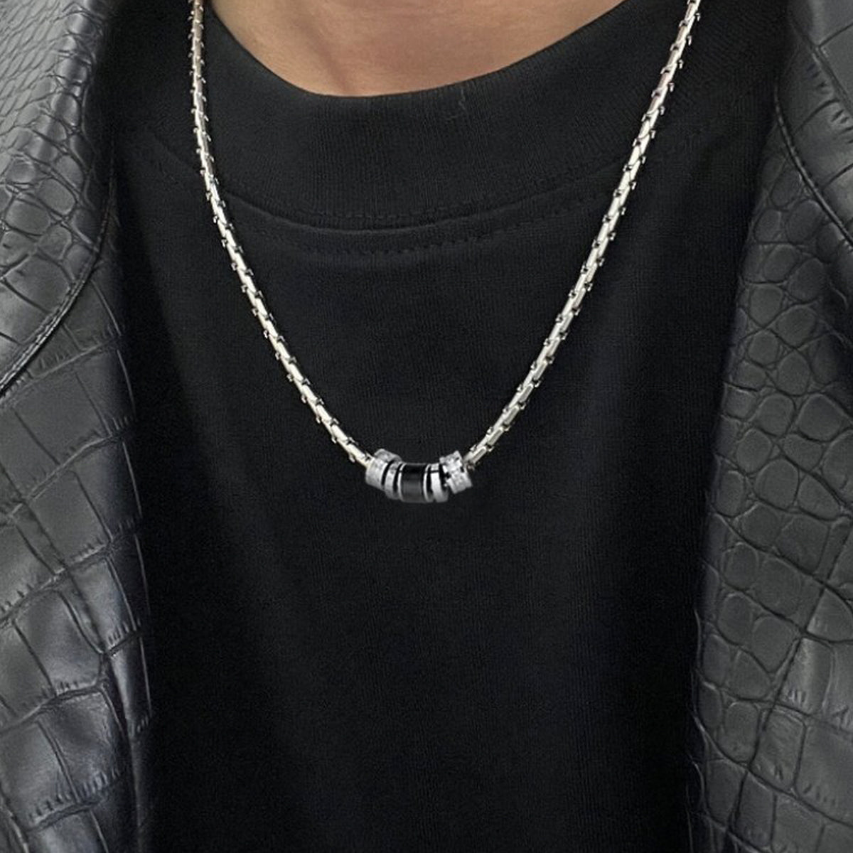 Men's Barrel Accent Necklace styled over a black shirt with layered silver-tone chains